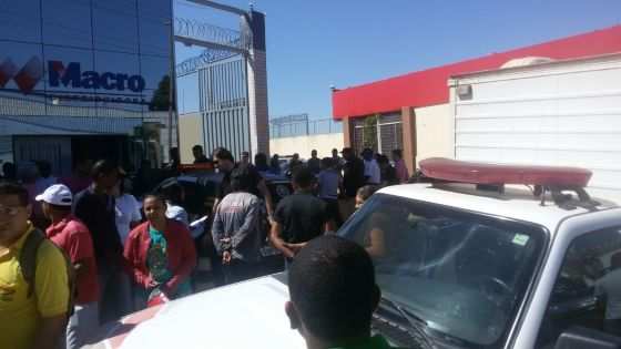 Neste momento, populares formam tumulto em frente à loja.