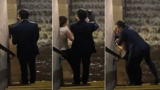 Mulher solidária ajuda homem em enchente 