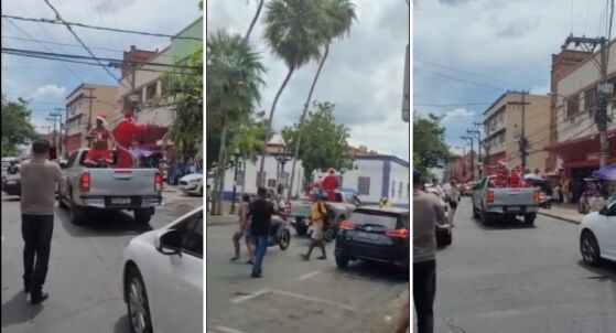 Dupla fantasiada de Papai e Mamãe Noel distribuíram corote no centro de Cuiabá.