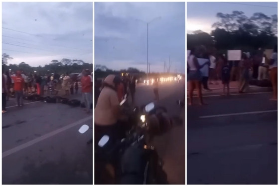 Com faixas, cartazes e palavras de ordem, os moradores bloquearam os dois sentidos da avenida com pneus, pedras e madeira