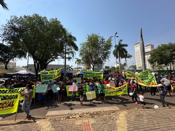 Com cartazes e tampas de panela, eles pedem para permanecerem na área invadida do Contorno Leste.
