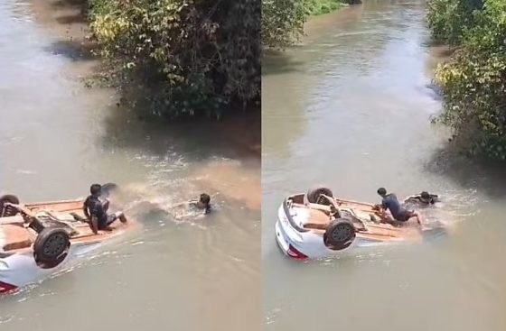 Populares quebraram o vidro do automóvel submerso para resgatar a criança.